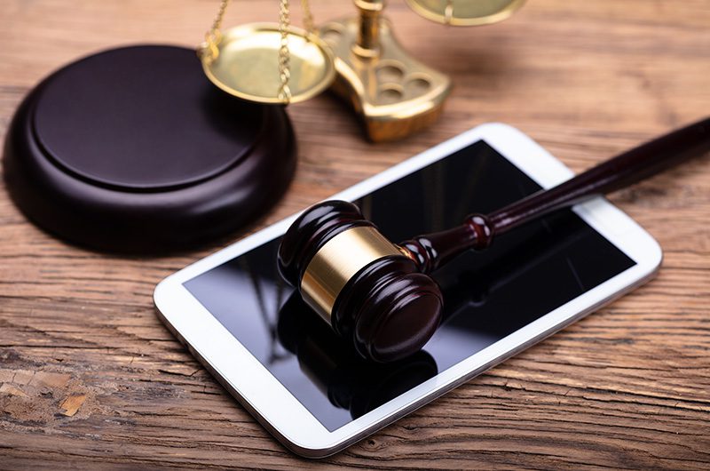 Gavel, Phone and Scales of Justice on a desk